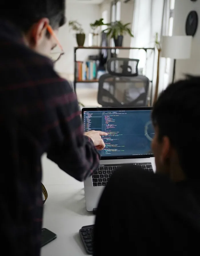 Two of the team looking at a laptop together